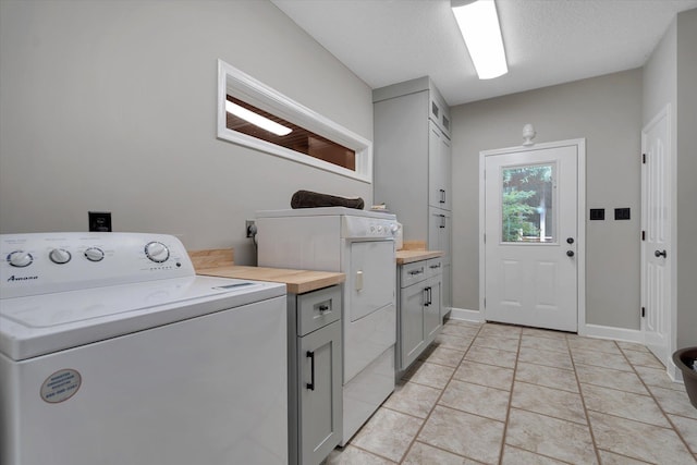 15355 Pleasant Grove Ln, Harrisburg, AR 72432 - washroom featuring washer / dryer, cabinet space, and light tile patterned floors