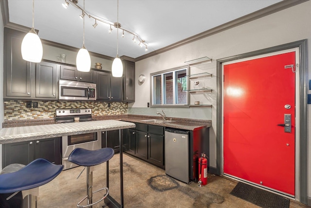 15355 Pleasant Grove Ln, Harrisburg, AR 72432 - kitchen featuring stainless steel appliances, crown molding, finished concrete floors, decorative backsplash, and rail lighting