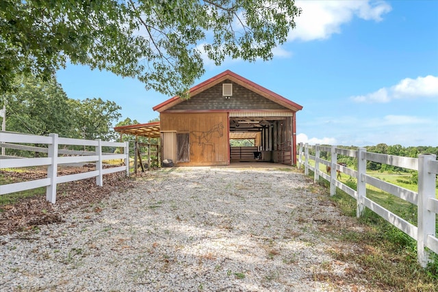 15355 Pleasant Grove Ln, Harrisburg, AR 72432 - exterior space featuring an exterior structure, a carport, an outbuilding, and gravel driveway