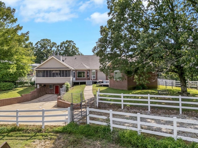 15355 Pleasant Grove Ln, Harrisburg, AR 72432 - view of front of home with a sunroom, a fenced backyard, a deck, and brick siding