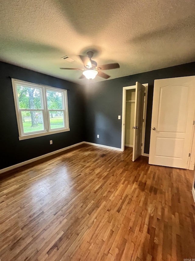 1505 W Park Ave, Searcy, AR 72143 - spare room with wood finished floors, a textured ceiling, and ceiling fan