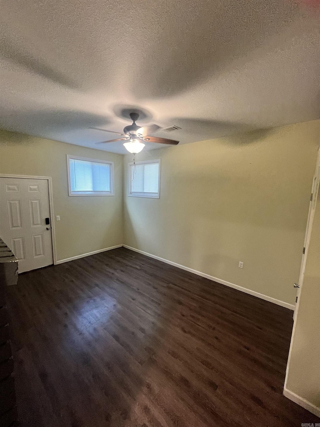 1505 W Park Ave, Searcy, AR 72143 - empty room with a textured ceiling, a ceiling fan, and dark wood-style flooring