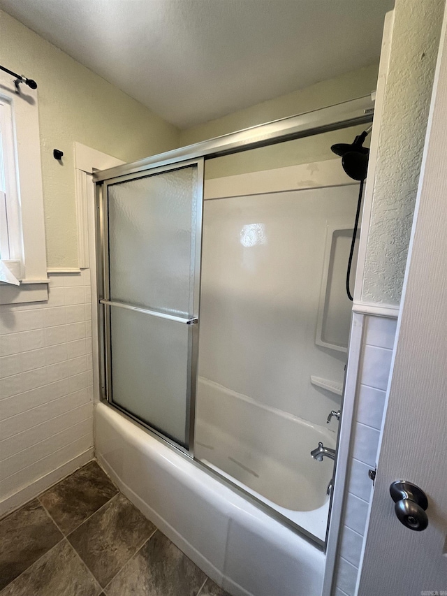 1505 W Park Ave, Searcy, AR 72143 - full bathroom featuring shower / bath combination with glass door, wainscoting, and tile walls