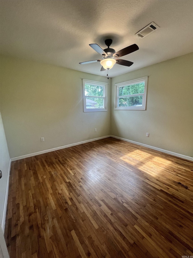 1505 W Park Ave, Searcy, AR 72143 - unfurnished room with dark wood-style flooring, a ceiling fan, and a textured ceiling