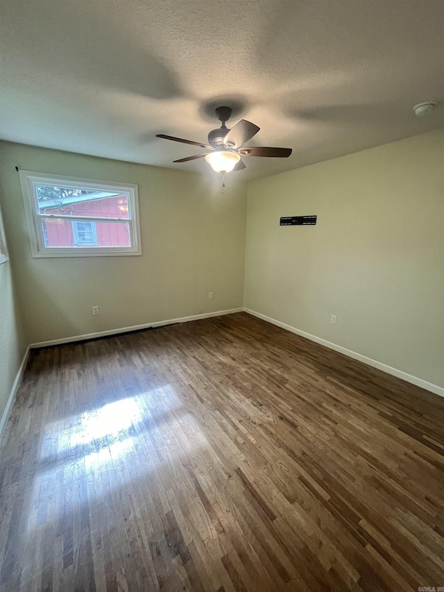 1505 W Park Ave, Searcy, AR 72143 - spare room featuring dark wood-style floors, ceiling fan, and a textured ceiling