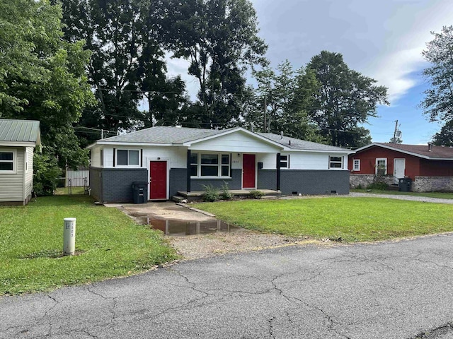 1505 W Park Ave, Searcy, AR 72143 - view of front of house with brick siding, a front yard, and a shingled roof