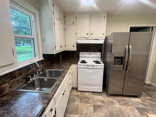 1505 W Park Ave, Searcy, AR 72143 - kitchen featuring stainless steel fridge, electric stove, under cabinet range hood, dark countertops, and white cabinets