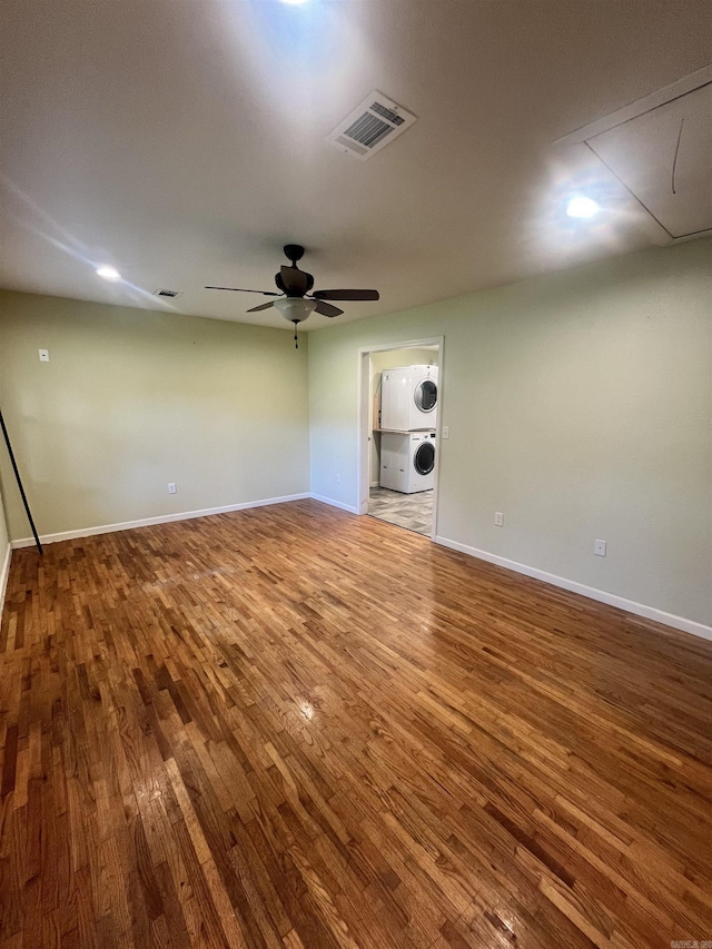 1505 W Park Ave, Searcy, AR 72143 - empty room with estacked washer and dryer, attic access, wood finished floors, and a ceiling fan