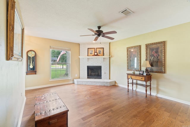 101 Rolling Oaks Dr, Maumelle, AR 72113 - living room featuring wood finished floors, ceiling fan, and a fireplace