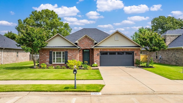 traditional home with brick siding, an attached garage, and a front lawn