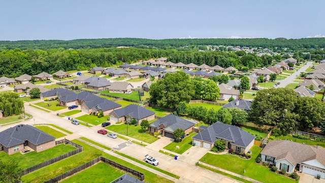 aerial perspective of suburban area featuring a heavily wooded area
