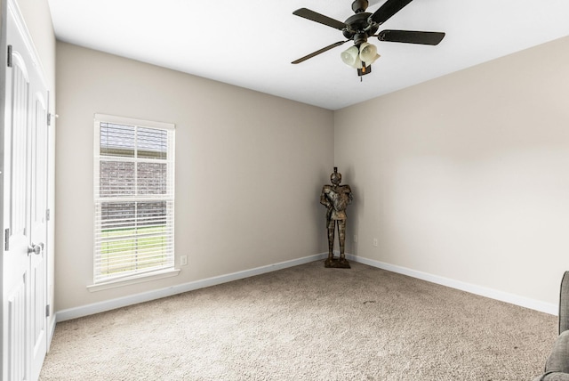 spare room with carpet flooring and ceiling fan