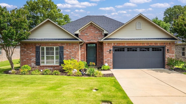 view of front of home with brick siding, driveway, a front lawn, roof with shingles, and an attached garage