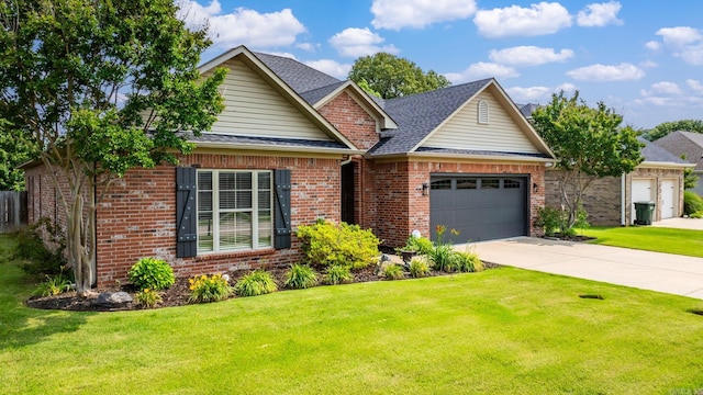 traditional-style house with a garage, brick siding, a front yard, and concrete driveway