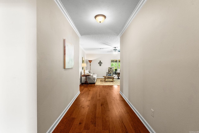 hallway with ornamental molding and hardwood / wood-style flooring