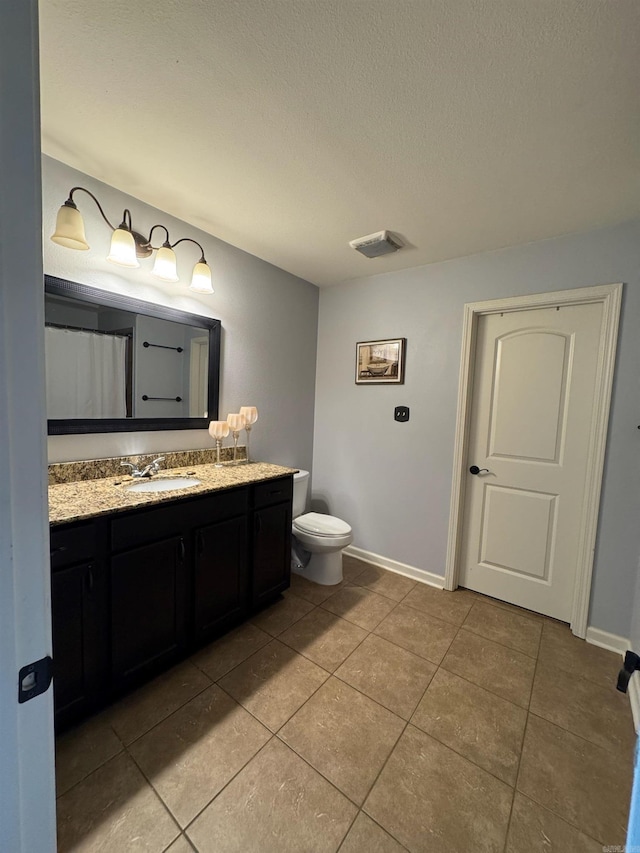 bathroom with vanity, tile patterned flooring, and a textured ceiling