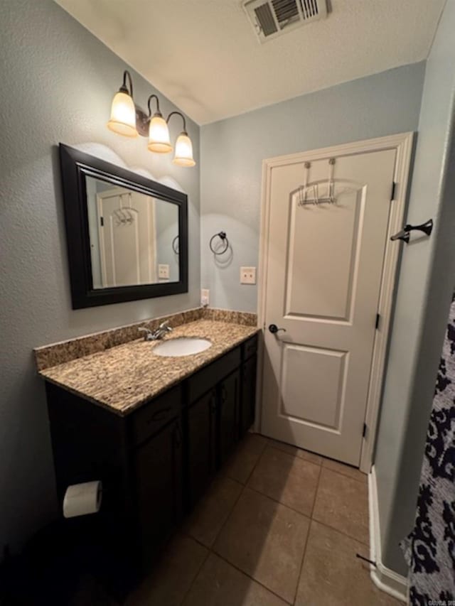 bathroom with vanity and tile patterned flooring