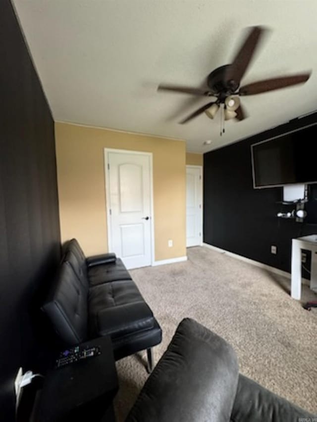 living room with a ceiling fan and carpet flooring