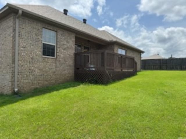back of house with a deck and brick siding