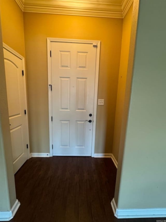 hallway with ornamental molding and wood finished floors