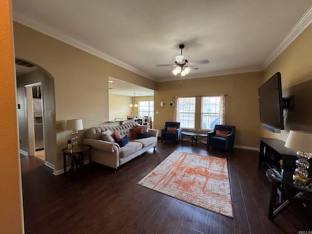 living room featuring ceiling fan, wood finished floors, ornamental molding, and arched walkways