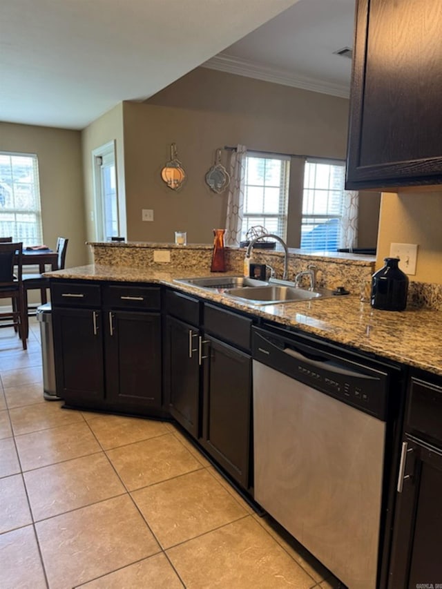 kitchen with dishwasher, healthy amount of natural light, light tile patterned floors, light stone counters, and ornamental molding