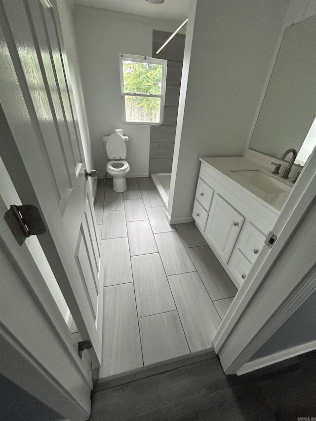 261 E Military, North Little Rock, AR 72118 - bathroom featuring vanity, a shower, and wood finished floors