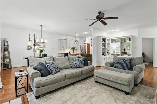2716 Juniper Dr, Benton, AR 72015 - living room with a ceiling fan, ornamental molding, wood finished floors, and a chandelier