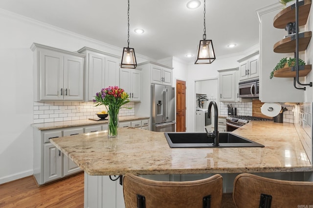 2716 Juniper Dr, Benton, AR 72015 - kitchen with appliances with stainless steel finishes, a peninsula, open shelves, decorative backsplash, and hanging light fixtures