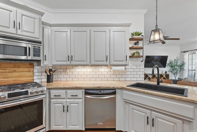 2716 Juniper Dr, Benton, AR 72015 - kitchen featuring stainless steel appliances, backsplash, ornamental molding, a ceiling fan, and hanging light fixtures