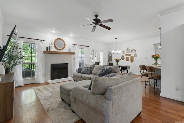 2716 Juniper Dr, Benton, AR 72015 - living room featuring healthy amount of natural light, a ceiling fan, ornamental molding, dark wood finished floors, and a fireplace with flush hearth