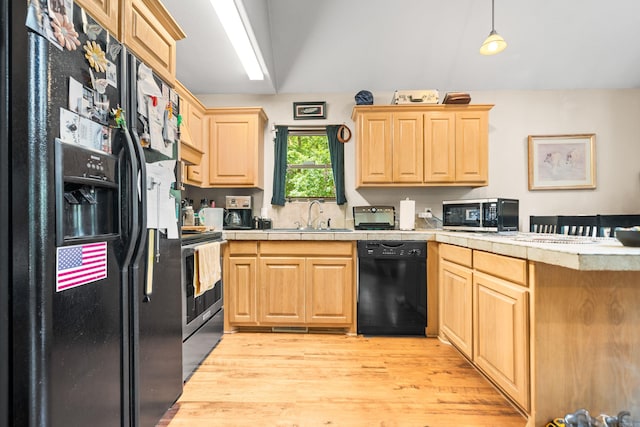232 Alydar Trl, Hot Springs, AR 71901 - kitchen featuring black appliances, a peninsula, light brown cabinets, light wood-type flooring, and decorative light fixtures