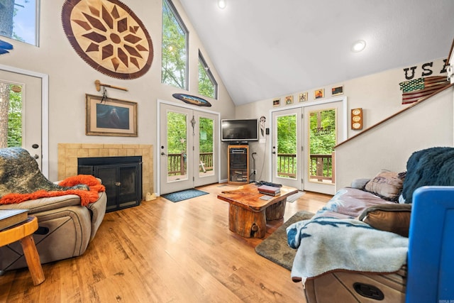 232 Alydar Trl, Hot Springs, AR 71901 - living room featuring high vaulted ceiling, a tiled fireplace, healthy amount of natural light, and wood finished floors
