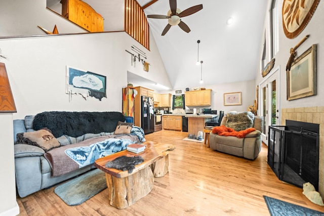 232 Alydar Trl, Hot Springs, AR 71901 - living room featuring a ceiling fan, high vaulted ceiling, light wood finished floors, and a tile fireplace