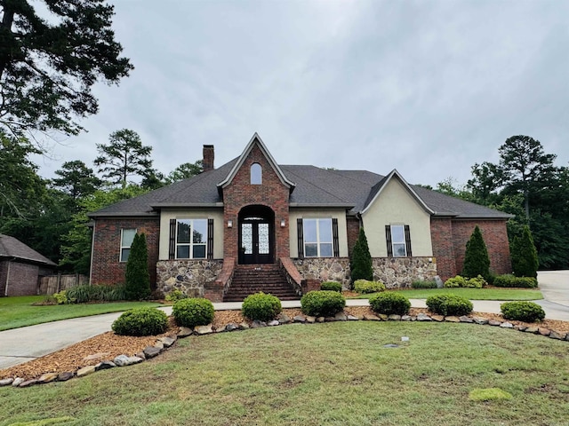 350 Wellesley, Conway, AR 72034 - view of front facade featuring a chimney, a front lawn, stone siding, french doors, and stucco siding