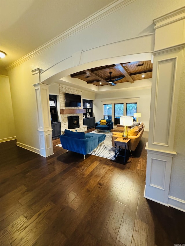 350 Wellesley, Conway, AR 72034 - living room with dark wood finished floors, a ceiling fan, a stone fireplace, a wood ceiling with exposed beams, and decorative columns