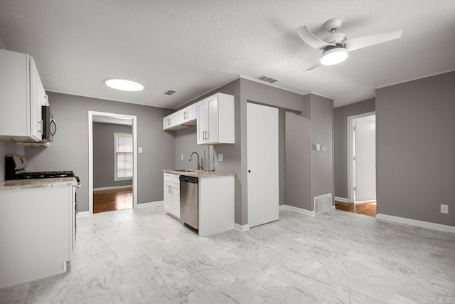 2911 Wynne Dr, Little Rock, AR 72204 - kitchen featuring stainless steel appliances, light marble finish flooring, ceiling fan, white cabinets, and a textured ceiling