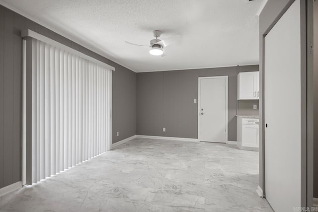 2911 Wynne Dr, Little Rock, AR 72204 - unfurnished room featuring ceiling fan, a textured ceiling, light marble finish flooring, and crown molding