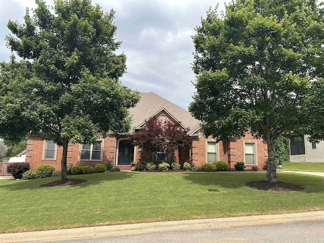 2205 Vermont St, Conway, AR 72034 - obstructed view of property featuring a front lawn and brick siding