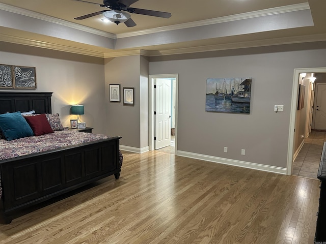 2205 Vermont St, Conway, AR 72034 - bedroom featuring light wood-type flooring, a tray ceiling, ornamental molding, and ceiling fan