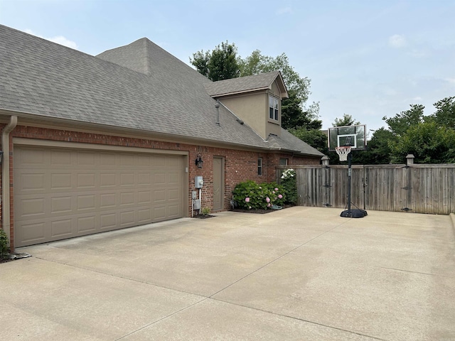 2205 Vermont St, Conway, AR 72034 - view of side of home featuring roof with shingles, brick siding, and concrete driveway