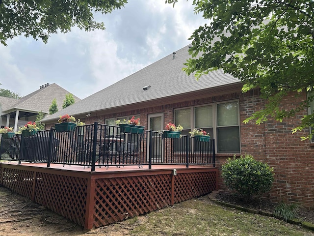 2205 Vermont St, Conway, AR 72034 - back of house with brick siding, a wooden deck, and a shingled roof