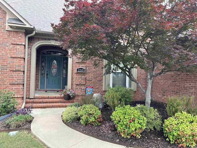 2205 Vermont St, Conway, AR 72034 - view of exterior entry featuring roof with shingles and brick siding