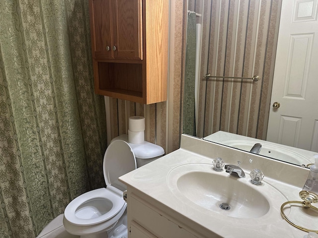 bathroom with wallpapered walls, vanity, and a shower with curtain