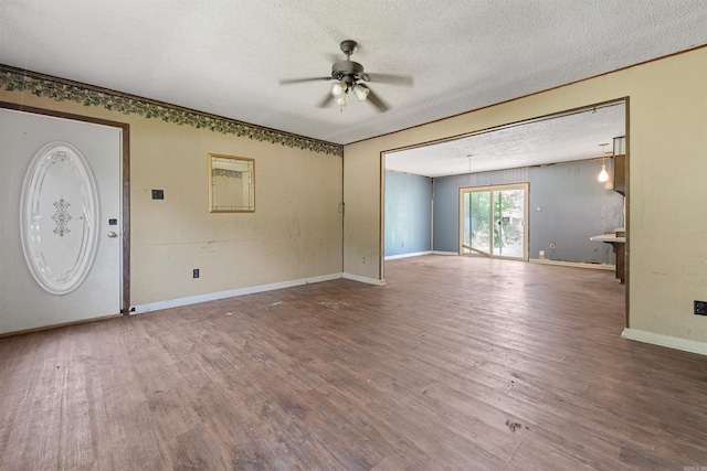 27 Arbor Oaks Dr, Sherwood, AR 72120 - unfurnished living room with a textured ceiling, a ceiling fan, and wood finished floors