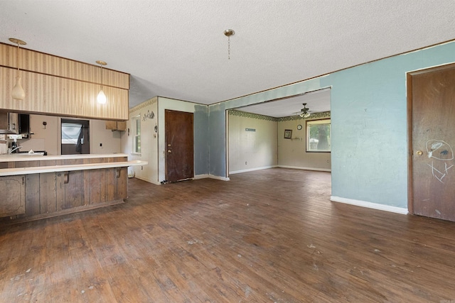 27 Arbor Oaks Dr, Sherwood, AR 72120 - kitchen featuring a textured ceiling, ceiling fan, wood-type flooring, open floor plan, and light countertops