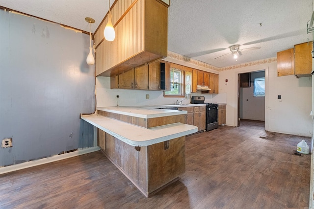 27 Arbor Oaks Dr, Sherwood, AR 72120 - kitchen with range with gas cooktop, a peninsula, a textured ceiling, under cabinet range hood, and dark wood-style flooring