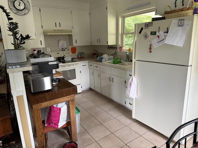 510 N 4th St, Heber Springs, AR 72543 - kitchen featuring white appliances, under cabinet range hood, light countertops, light tile patterned floors, and white cabinetry