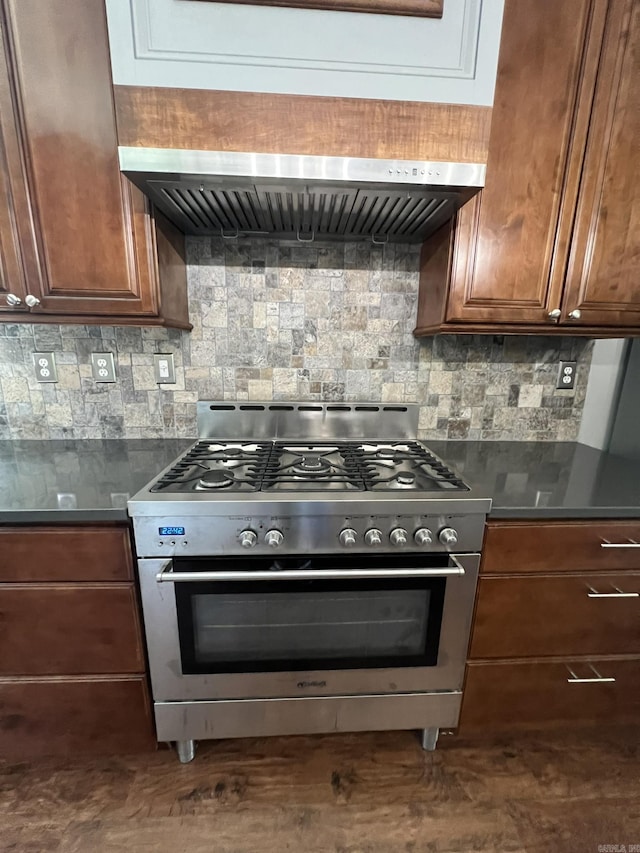 5942 Joey Ln, Texarkana, AR 71854 - kitchen with stainless steel range, decorative backsplash, range hood, and dark countertops