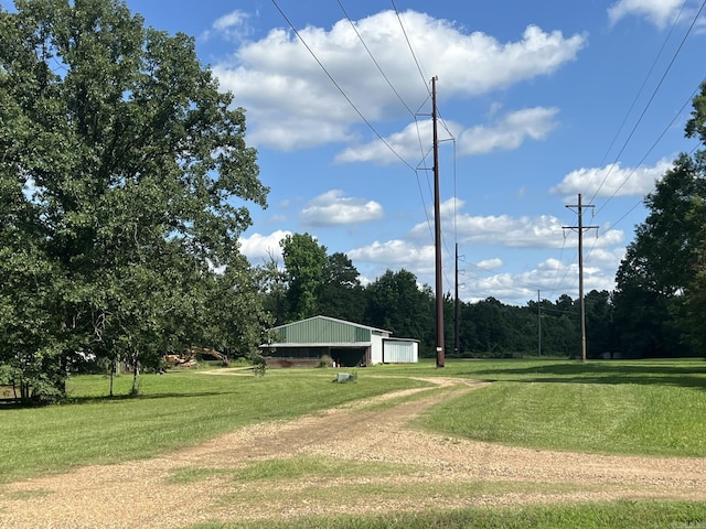 5942 Joey Ln, Texarkana, AR 71854 - view of community with a detached garage, a lawn, and an outdoor structure